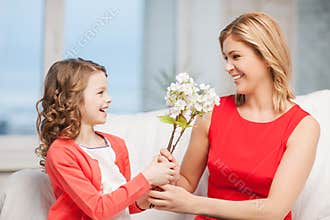 Happy mother and daughter with flowers