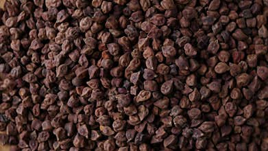 Raw Dark Brown Chickpeas (Kala Chana) on a rustic wooden table.