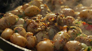 A large frying pan is being used to cook potatoes.