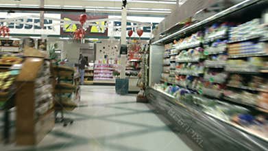 Shopping cart racing through grocery aisles in time lapse