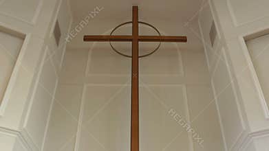 Tilt from open bible to cross on church wall