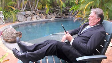 Businessman Walks By Pool