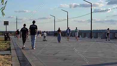 Ukraine: Teenagers riding scooters along river promenade, Mykolaiv, Ukraine 29 Jun 2025
