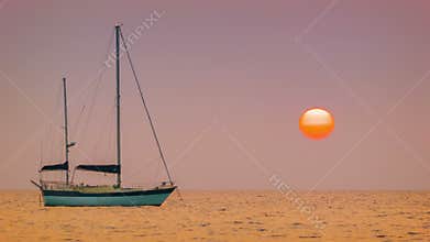 Sailing yacht in the bay. Tropical sunset