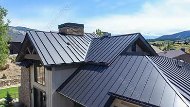 Modern house featuring a standing seam metal roof in a mountain residential area