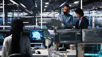 Data center manager supervising work done by programmers on neural network