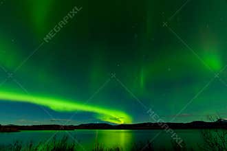 Aurora borealis show Lake Laberge surface mirrored