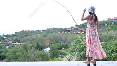 Photoshoot woman stand on pool edge with tranquil hilltop view background