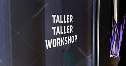 Startup Factory with Bilingual Workshop Sign and Plant