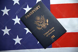 USA passport top view placed on the American flag in the background. Travel document for United States citizen concept