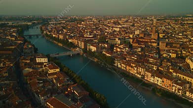 Aerial View of Verona Showcasing the Adige River and Historic Architecture During Golden Hour.