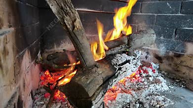 Burning firewood in a fireplace, vivid burning flames.
