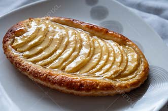 French fresh baked sweet puff pastry with fresh apple fruits in sirup in confectionery shop
