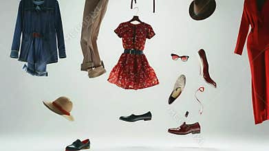 Clothing and accessories floating in mid-air against a white background