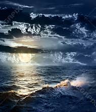 Stormy sea at Night with dramatic sky and the big Moon