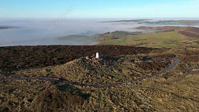 Cinematic aerial orbit reveal shot from the trig point on The Roaches in winter