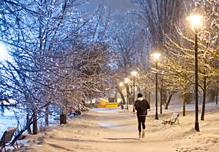 Night running in the snowy park
