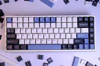 Close Up Modern 75% Layout Mechanical Keyboard with White, Blue, and Black Keycaps on a Clean White Desk