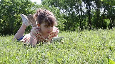 Little girl playing with tablet pc
