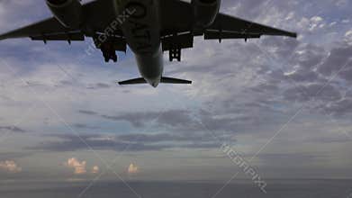 Airplane before landing over sea at morning