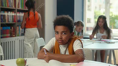 School library education class smiling African American happy little boy student pupil schoolboy learner child kid son