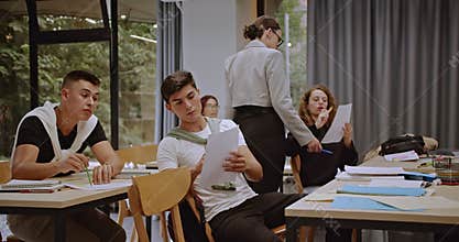Students Studying with Their Professor After Class in a Modern Classroom