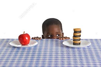 Child Tempted By Cookies While Choosing Between Healthy and Unhealthy Snacks