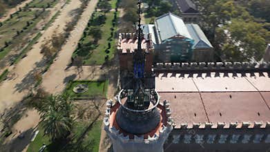 Drone flight circling over the Catalan Castle of Tres Dragons inside Ciutadella Park in Barcelona