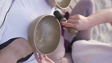 A video displays sound healing with singing bowls for relaxation