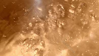 Closeups of bubbles forming and rising highlighting the dynamic transformation of water as it heats