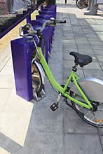 Green bicycle parking and lock in urban city walking ways