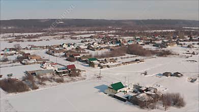 Snowy Russian village panning across winter landscape