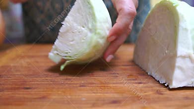 Slicing vegetables cabbage. Female hands cut carrot on a wooden cutting board. Cooking in the kitchen. Food preparation
