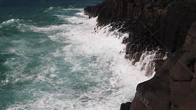 Waves crashing wildly onto high basalt cliffs on the East coast of Australia.