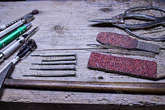 \"Vintage Watchmaker\'s Tools on Rustic Wooden Table – Legacy of a Master Craftsman\"