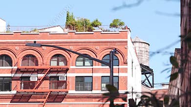 New York City Manhattan architecture, USA. Residential house exterior. Red brick facade, water tower