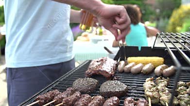 Close Up Of Of Man Cooking On Barbeque At Home