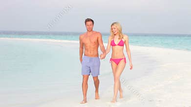 Romantic Couple Walking On Beautiful Tropical Beach