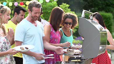 Group Of Friends Having Outdoor Barbeque At Home