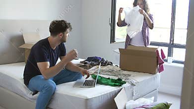 Couple Having Argument As Woman Packs To Leave