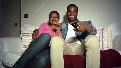 Young African American Couple On Sofa Watching TV Together