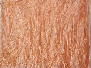 Abstrack orange crumpled plastic bag texture background
