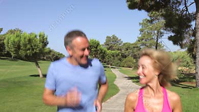 Senior Couple Jogging In Park