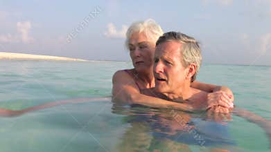 Senior Couple Relaxing In Tropical Sea