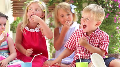 Children Enjoying Food At Party