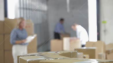 Shallow Focus Of Workers Taking Boxes From Belt