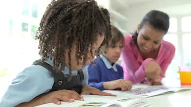 Mother Helping Children With Homework