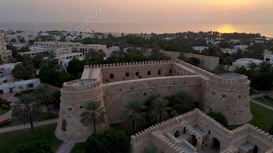 Aerial view of sur city and its ancient fortress during sunset