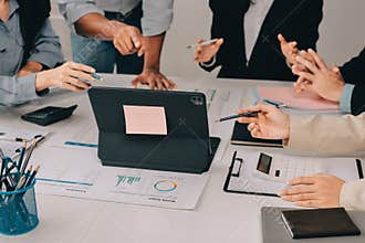 Team of financial advisory services. Asian advisor showing plan of investment to clients in the consultancy office