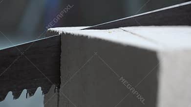 Stopping the process of sawing bricks with a saw.